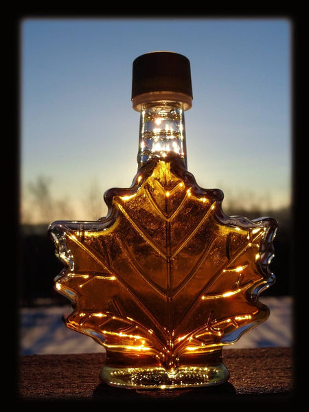 Maple leaf shaped bottle with maple syrup