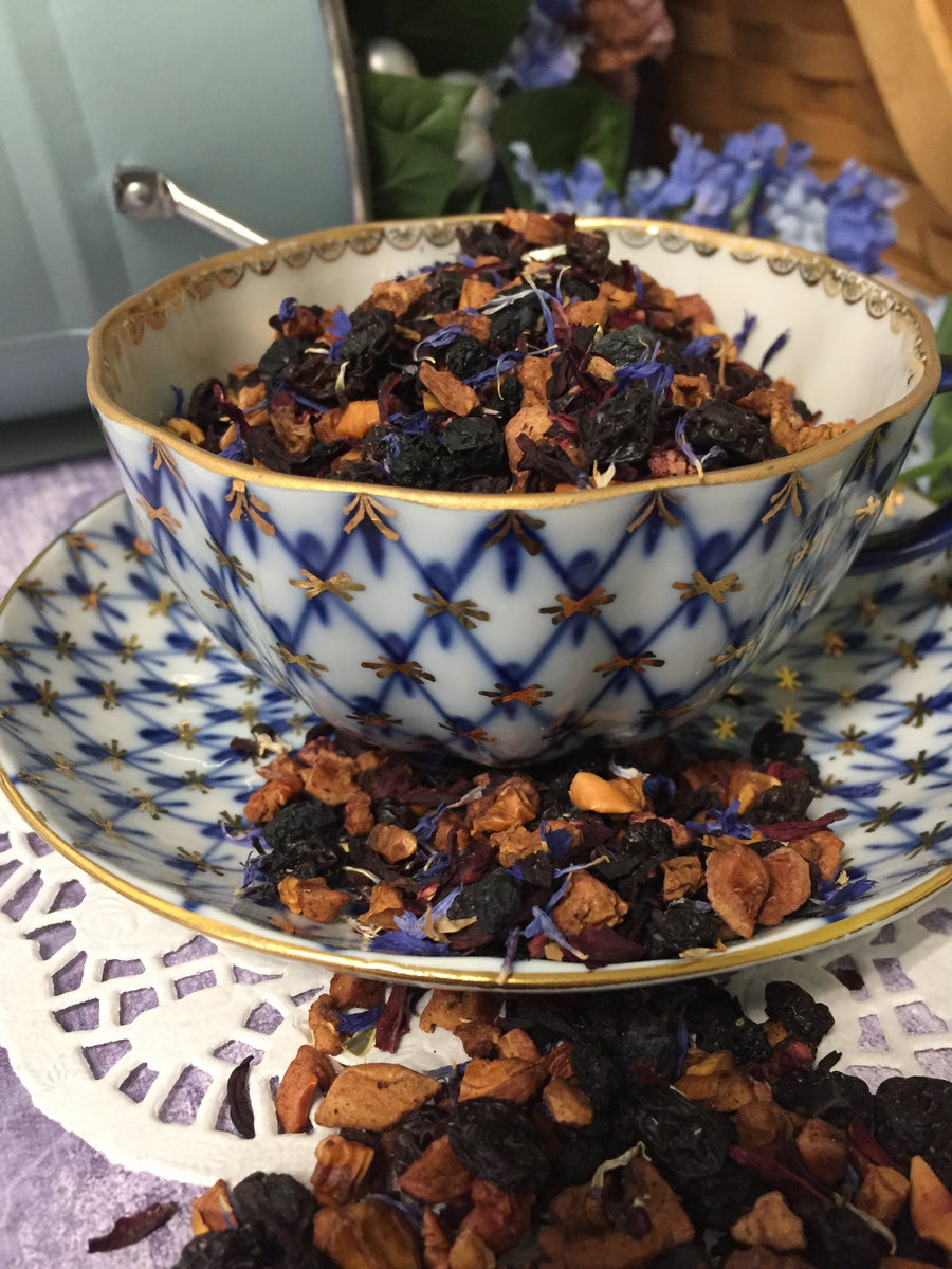 dried tea in porcelain cup that is decorated with blue and gold . The tea has an amazing appearance  