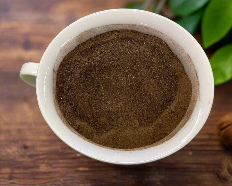 Amla powder from Glenbrook Farms rich brown color  in  a white cup 