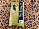 A package of TeaBrew TeBrew starter pack with 20 paper filters, placed on a brown patterned ceramic tile surface.