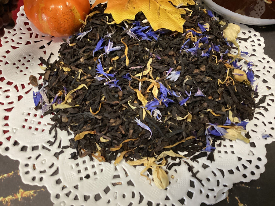 Black tea with dried flowers on a decorative doily