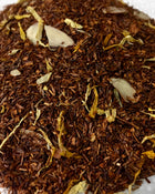 close up of vanilla almond tea with red rooibos and calendula almond pieces 