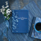 Beautiful  dark blue bible with sliver lettering and floral design down the side of the bible