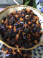 close up of dried tea in porcelain cup that is decorated with blue and gold . The tea has an amazing appearance  