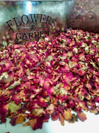 pile or red rose buds and petals