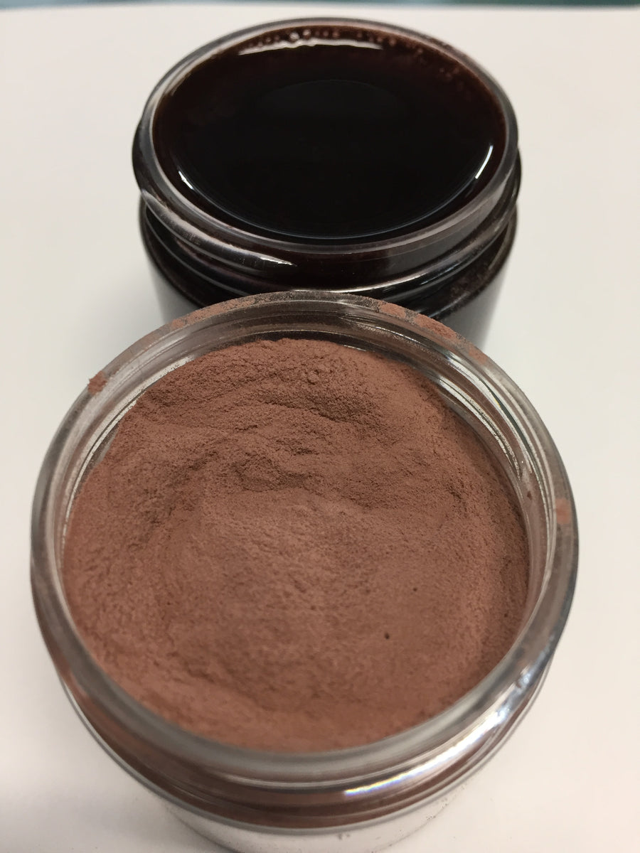 picture of the pinkish brown powder  and the deep black purple  reconstituted  powder in water 