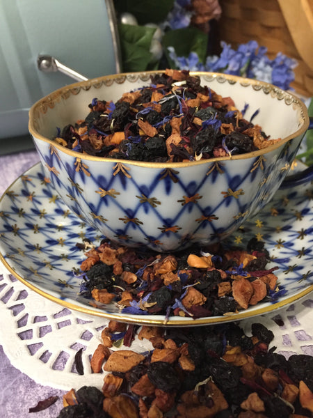 dried tea in porcelain cup that is decorated with blue and gold . The tea has an amazing appearance  