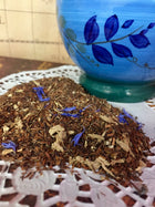 rooibis tea loose with spices by a blue cup