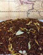 Vanilla Almond rooibos tea with pieces of almond and  calendula present.
