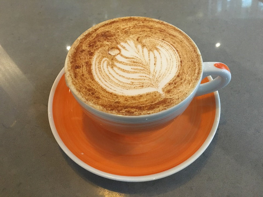 cup of chai-latte with a design in the cream